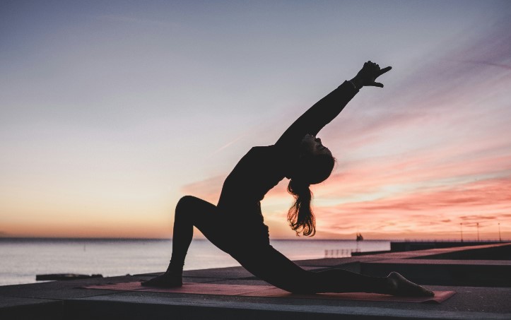 Woman practicing yoga at home